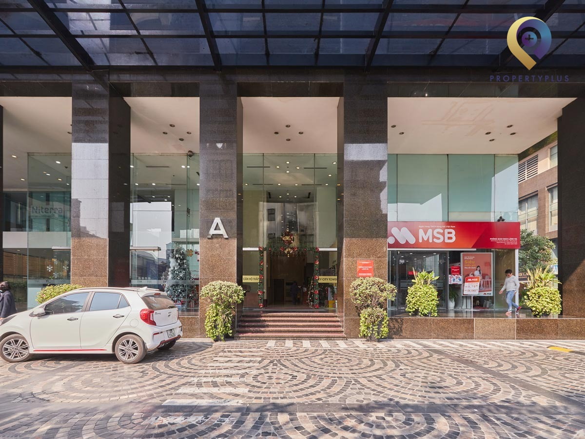 Main entrance of Sky City Towers with glass doors and clean pavement